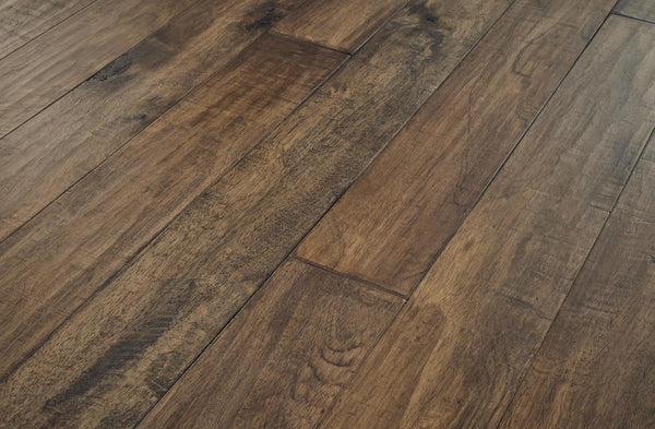 Close-up view of natural wooden floorboards with a rich brown finish, visible grain patterns, and subtle variations in color and texture.