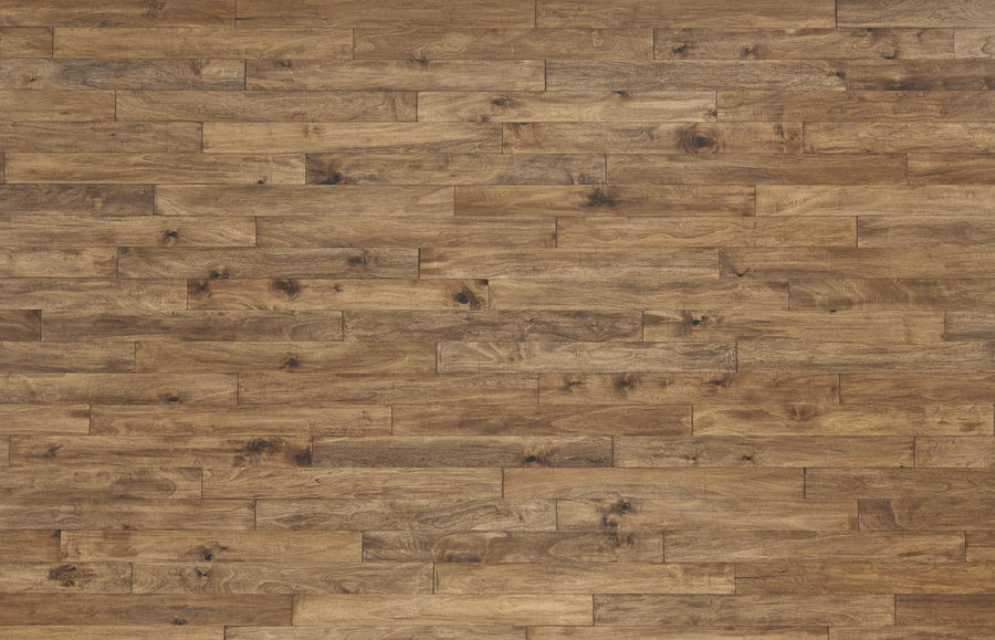 A close-up view of a wooden floor made of medium brown planks with visible natural grain patterns and knots. The planks are arranged in a staggered, horizontal pattern.