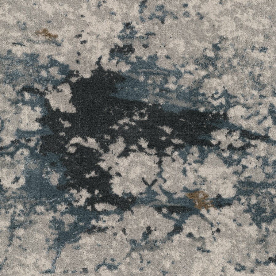 The Palisades On Trend Carpet features an abstract textured surface with irregular dark, blue, and brown splotches on light gray, creating a sophisticated, artful paint splatter pattern.
