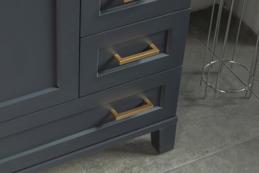 A close-up of a dark blue cabinet with gold handles, standing on a gray tiled floor. Part of a metal stand is visible in the background.