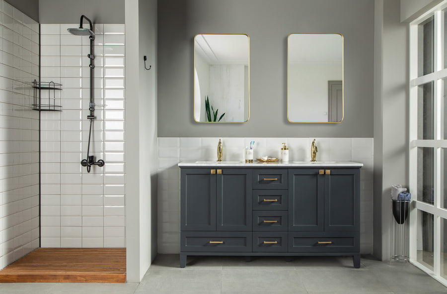 Modern bathroom with a walk-in shower, Paloma 60" Double Bowl Vanity in navy blue with gold handles and soft-close drawers, double sinks with mirrors above, and classic gray and white tiled walls.