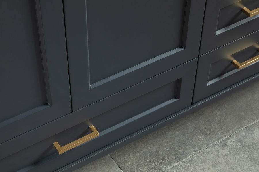 Close-up of dark blue cabinets with gold rectangular handles, set against a gray tile floor. The cabinet features a modern, paneled design.