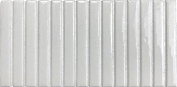 The Parallel 4.5 x 9.1 Glazed Porcelain Tile is a rectangular, white tile with a glossy finish and vertical, evenly spaced raised ridges that create a bold fluted design for added texture and visual depth.