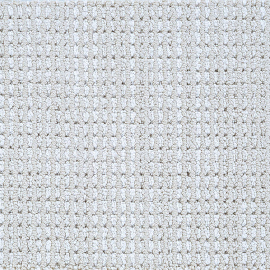 Close-up of Top Notch Berber Carpet in Parchment color, showing a soft surface with evenly spaced loops in a subtle, raised checkerboard pattern—a stylish and premium flooring option.