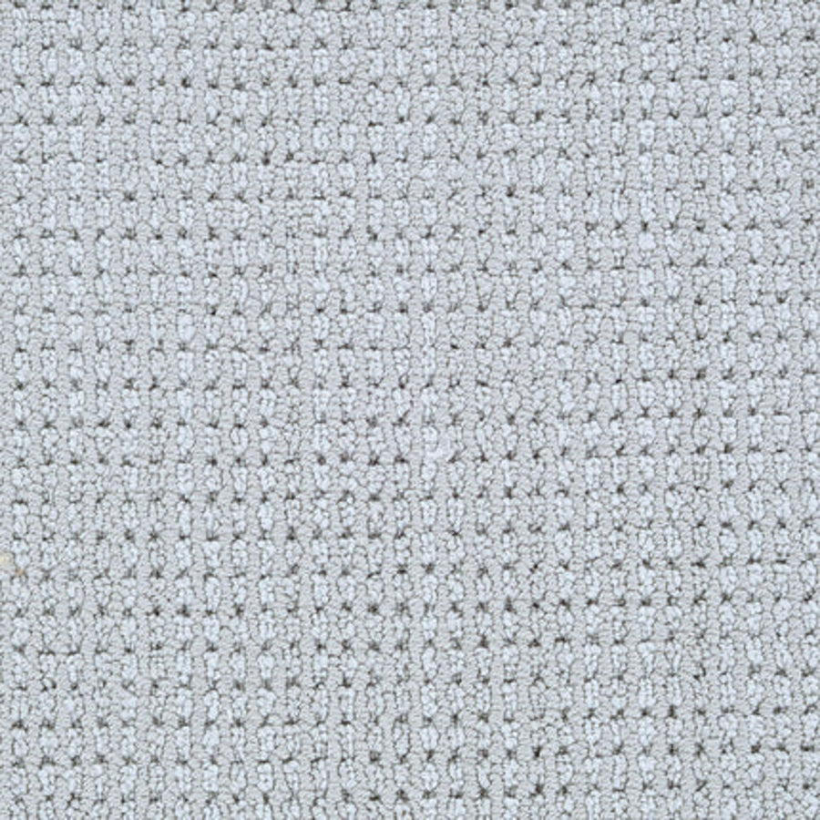Close-up of Top Notch Berber Carpet in Pavement, featuring a light gray hue with a small square waffle pattern. This premium flooring is soft, evenly woven, and offers outstanding stain resistance.