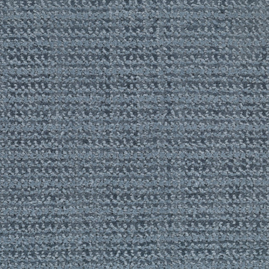 A close-up view of the Beguiling Berber Carpet in Peaceful, featuring a textured surface and a subtle grid pattern formed by raised and lower rows, showcases this luxurious flooring option.