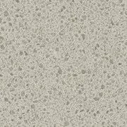 Close-up of the Marble Sill 6x72 in Pebble, showcasing its light gray, speckled surface with a rough texture and small dark spots throughout, highlighted by a polished edge that emphasizes its refined finish.