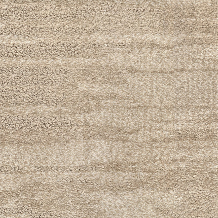A close-up of Cirrus Berber Carpet in Pebble shows soft, textured luxury with blended light and darker fibers, creating a subtle pattern ideal for premium flooring.