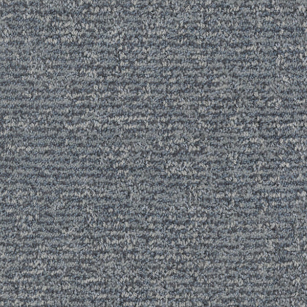 Close-up of Balance Family Friendly Carpet in Placid, featuring a blue-gray textured surface with subtle linear patterns. Soft, densely woven fibers provide a uniform yet varied look, while ensuring durability and stain resistance.