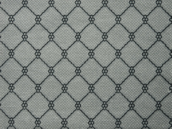 Lake Boden Berber Carpet in Platinum features a gray base with repeating diamond lattice patterns of black lines and clustered dots, creating a geometric, textured look ideal for durable flooring in any modern home.