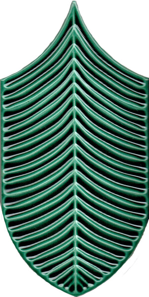 The Plume 4x8 Ceramic Tile features a green, stylized symmetrical leaf with raised rib-like geometric veins, inspired by tropical tile design on a white background.