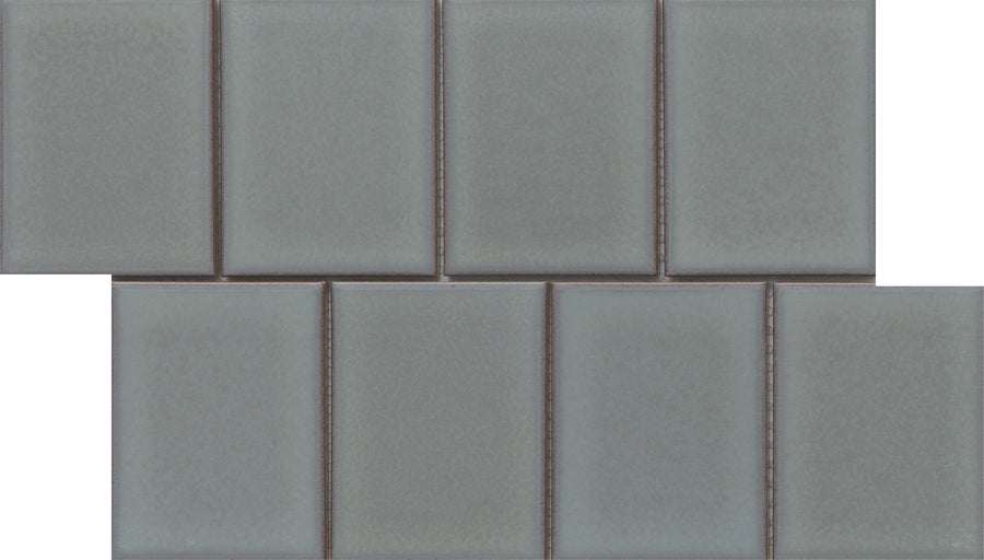 Marco and Polo 4x5 Glossy Porcelain Tiles in Polo Gray are arranged in a brick pattern with each row slightly offset. Their glossy, frameless design offers a sleek, modern look perfect for contemporary spaces.