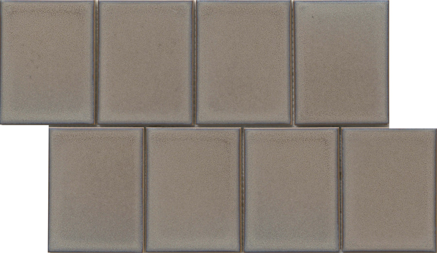 Seven Marco and Polo 4x5 Glossy Porcelain Tiles in Polo Tawny, arranged in two staggered rows (four on top, three below) for a brick-like, designer-inspired pattern.
