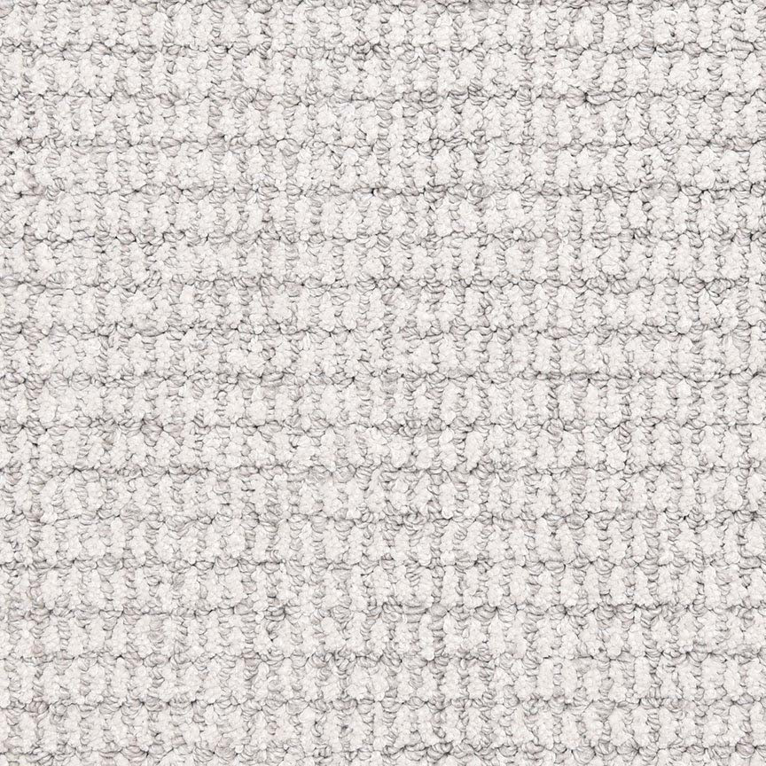 A close-up of Aspen Berber Carpet in Powder color, featuring a soft, textured grid pattern with looped fibers that create a raised, structured surface.