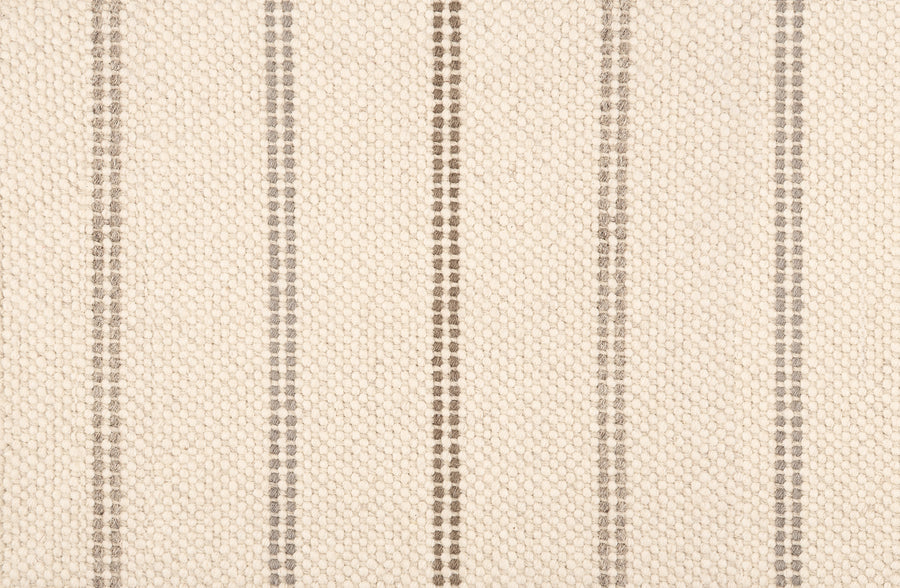 A close-up of Prairie Path On Trend Carpet shows a cream woven fabric with evenly spaced vertical brown stripes. The soft, slightly raised texture creates an elegant, refined appearance perfect for stylish interiors.