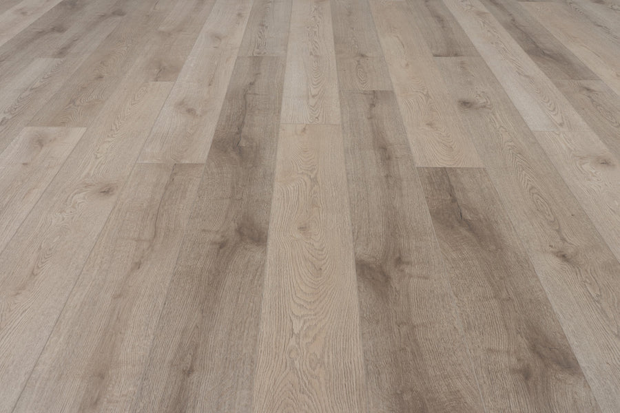 Concorde 7.2" Luxury Vinyl Plank features a light brown, wood-look finish with natural grain patterns and varied shades. Photographed from a low angle to showcase its textured surface and seamless alignment for a premium appearance.