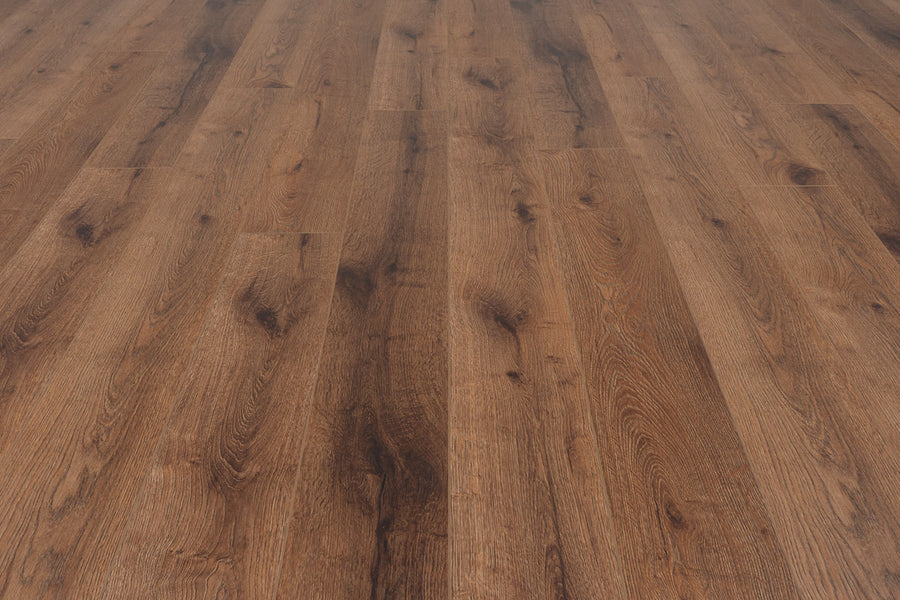 Close-up of Concorde 7.2" Luxury Vinyl Plank flooring in medium-dark brown, showcasing wood grain and knots, with planks arranged straight and parallel for a premium look.