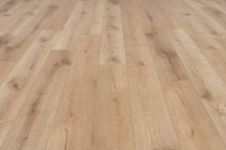 The image shows Concorde 7.2" Luxury Vinyl Plank flooring in light brown with a natural grain pattern and wide planks laid lengthwise, offering a warm, rustic wood-look finish. No furniture or other objects are visible.