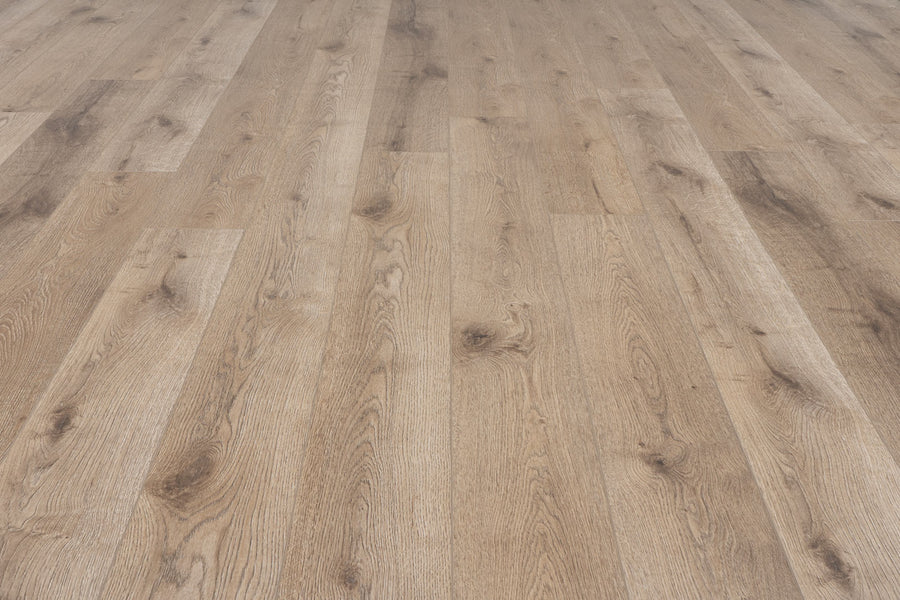 Concorde 7.2" Luxury Vinyl Plank offers a light brown wood-look floor with visible grain and knots, arranged in long planks. Its clean, polished finish adds an elegant touch to any space.