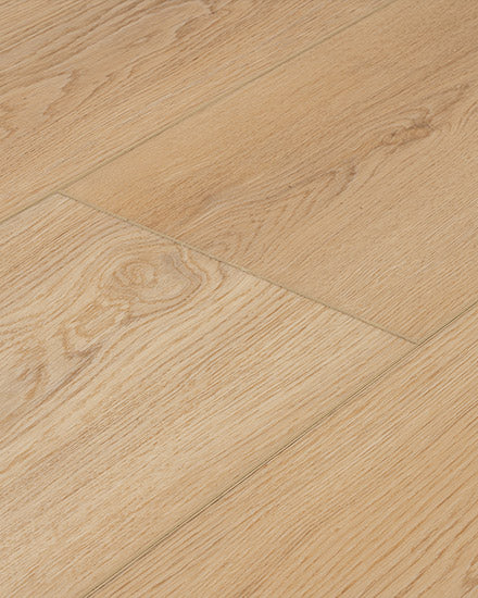 Close-up of Moda Living 7.15" Luxury Vinyl Plank flooring, featuring a light wood grain pattern and subtle texture. The planks are aligned side by side, with grooves and seams for an authentic wood-look finish.