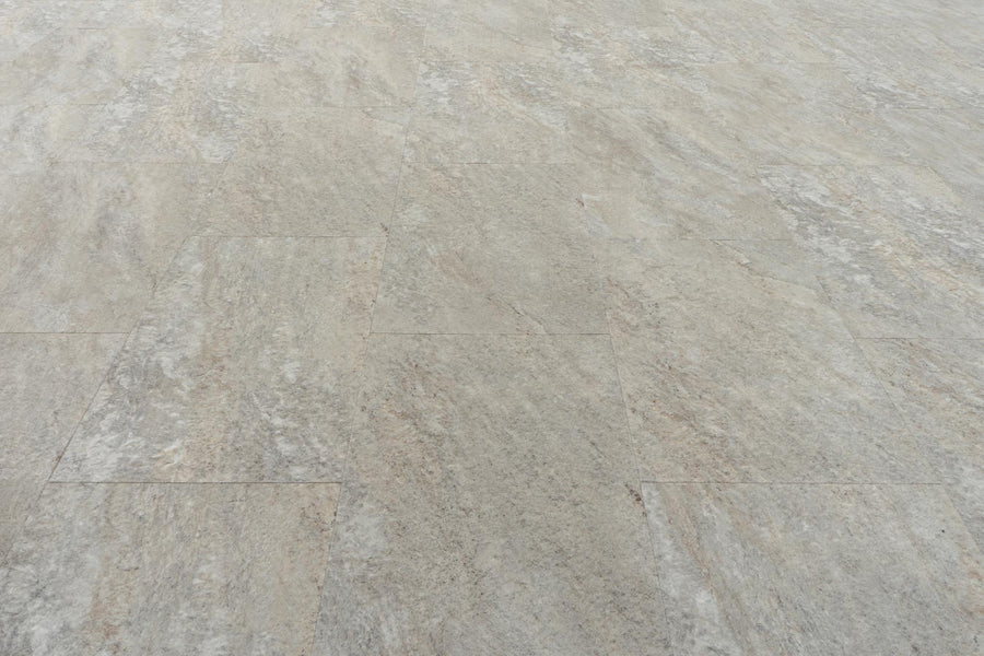 Stonescape Luxury Vinyl Plank features light gray textured flooring with subtle beige and brown streaks, a matte finish, and realistic stone aesthetics. Enjoy the look of natural stone plus the durability of luxury vinyl plank.