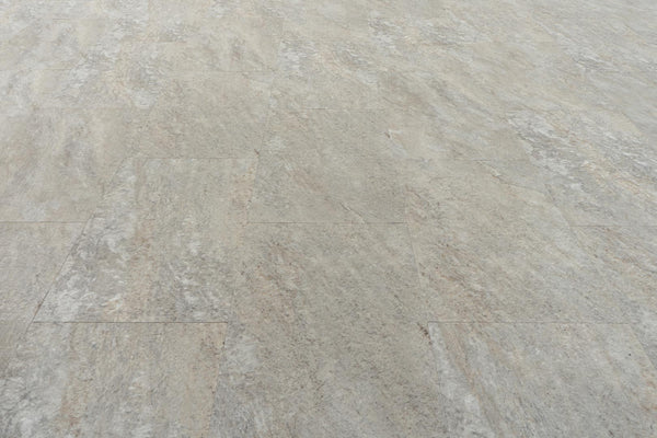 Stonescape Luxury Vinyl Plank features light gray textured flooring with subtle beige and brown streaks, a matte finish, and realistic stone aesthetics. Enjoy the look of natural stone plus the durability of luxury vinyl plank.