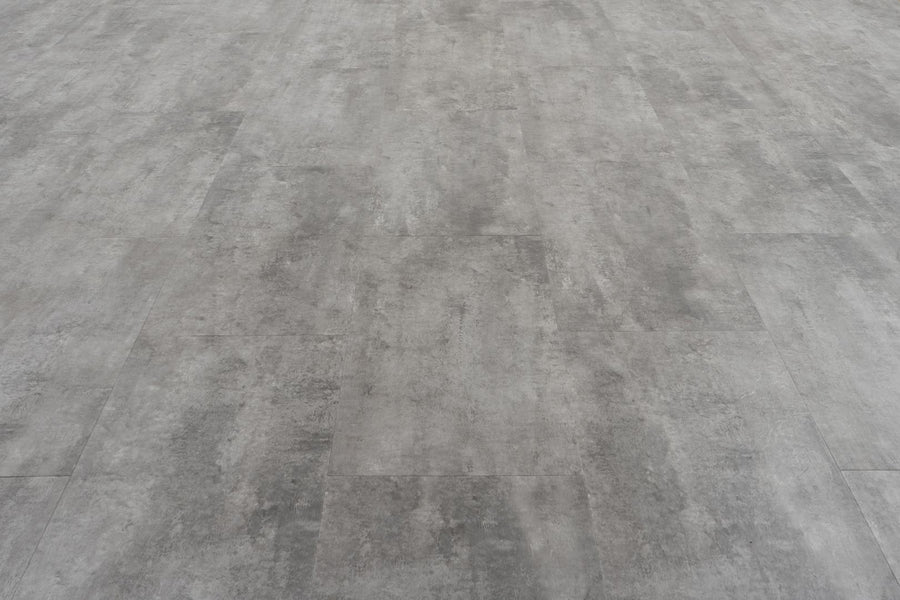 Stonescape Luxury Vinyl Plank features a gray concrete look with subtle shading and texture. Rectangular planks in a staggered layout offer durable, smooth, industrial stone aesthetics ideal for modern spaces.