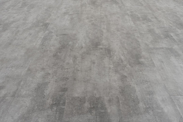 Stonescape Luxury Vinyl Plank features a gray concrete look with subtle shading and texture. Rectangular planks in a staggered layout offer durable, smooth, industrial stone aesthetics ideal for modern spaces.