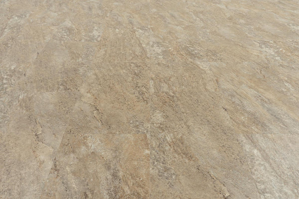 A close-up view of a textured, light brown floor showcases Stonescape 12x24 Luxury Vinyl Plank, featuring subtle color variations and natural-looking stone aesthetics.