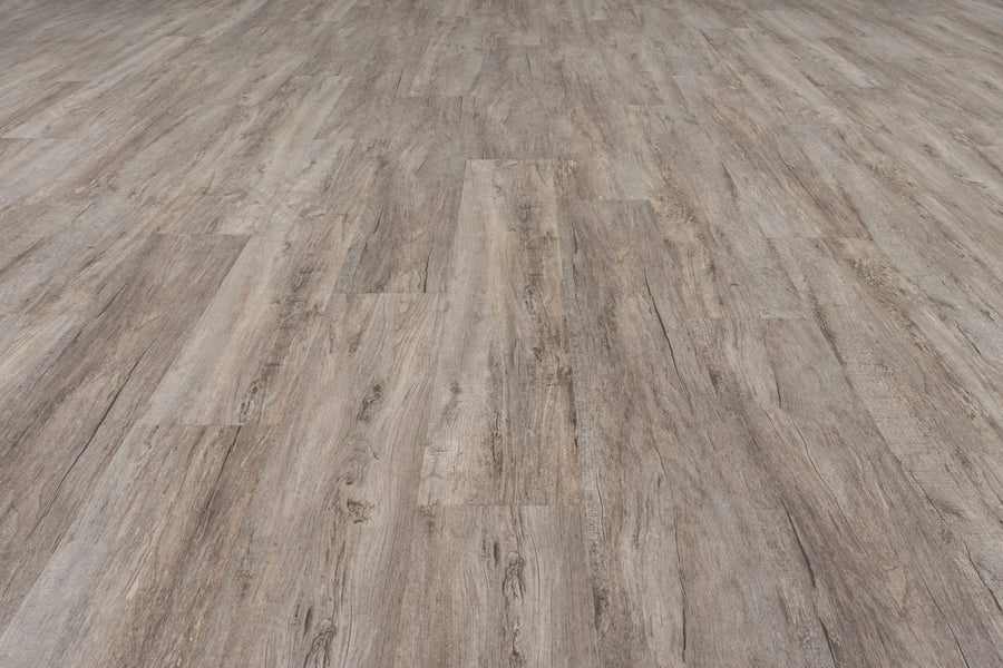 Close-up of Uptown Chic 7.15" Luxury Vinyl Plank flooring in light brown and gray tones, displaying realistic wood grain and diagonal plank seams.