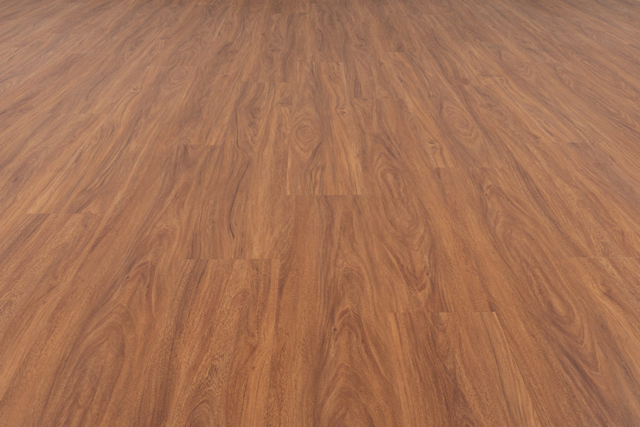 A seamless expanse of Uptown Chic 7.15" Luxury Vinyl Plank flooring with polished, reddish-brown tones and natural grain patterns, viewed from a low angle for depth and spaciousness.