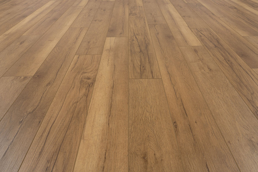 Close-up of Uptown Chic 7.15" Luxury Vinyl Plank flooring in light brown, featuring staggered planks that highlight the natural grain and texture.