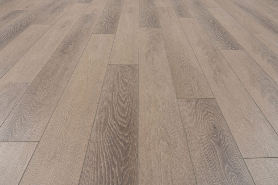 Close-up of Uptown Chic 7.15" Luxury Vinyl Plank flooring featuring staggered light and medium brown planks. Visible wood grain creates a natural, textured look.