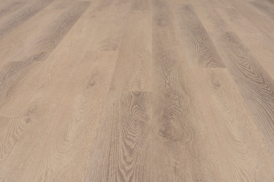 Close-up view of Uptown Chic 7.15" Luxury Vinyl Plank flooring, featuring light brown tones with visible wood grain patterns, evenly arranged planks extending into the distance.