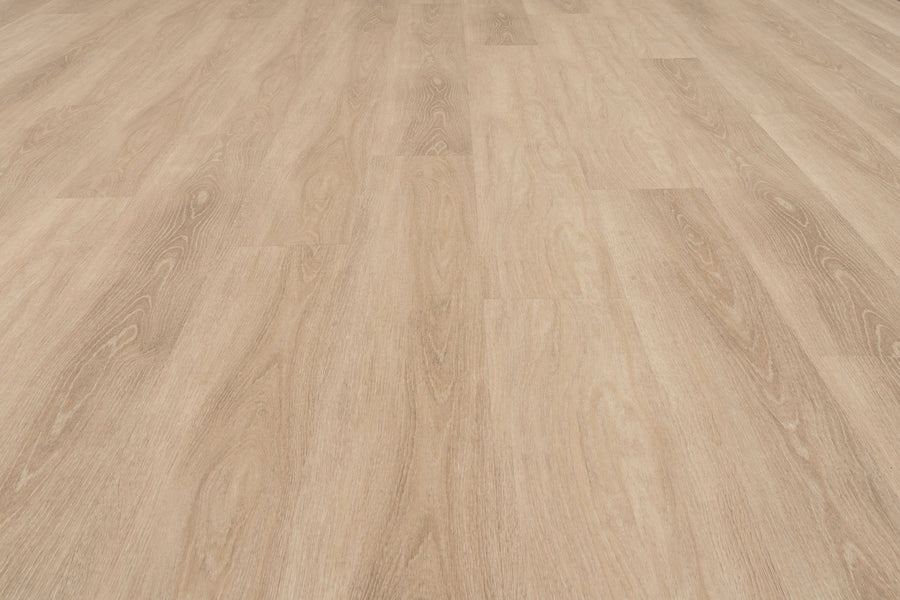 Uptown Chic 7.15" Luxury Vinyl Plank features a light brown wood look with visible grain and subtle texture. Planks are laid side by side for a uniform, clean surface, offering a warm, natural appearance when viewed from above.