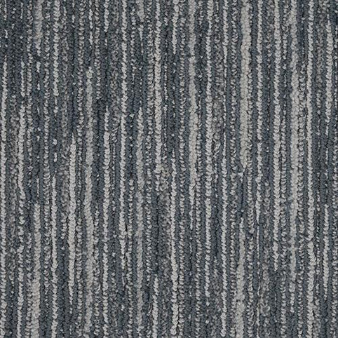 Close-up of the Artist View On Trend Carpet in Prussian Blue, showcasing a textured surface with vertical stripes. The pattern alternates between darker and lighter blue tones for a stylish, modern look in any space.