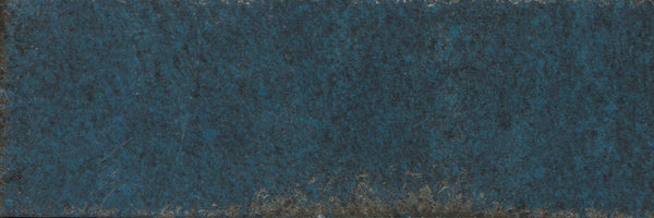 Catalyst 4x12 Porcelain Tile in Pulse Blue features a textured, rough surface with worn accents and a subtle multi-finish glaze, creating a weathered, distressed look.