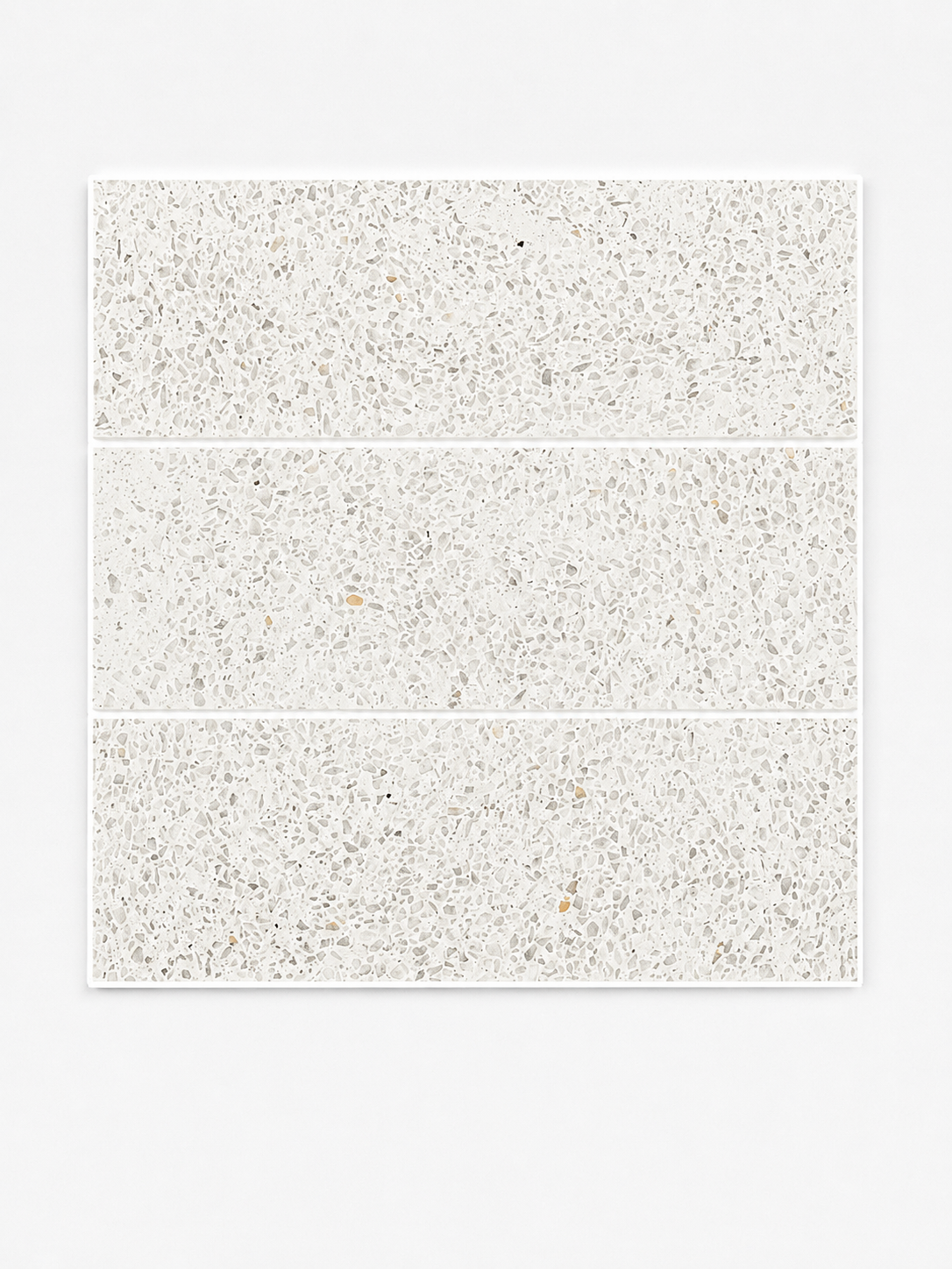 
		                            Three Revive Terazzo 4x12 Natural Stone tiles in the color Amplify, featuring a light gray and white speckled pattern reminiscent of elegant Dolomite Marble, are arranged in a vertical stack on a plain white background.
		                            