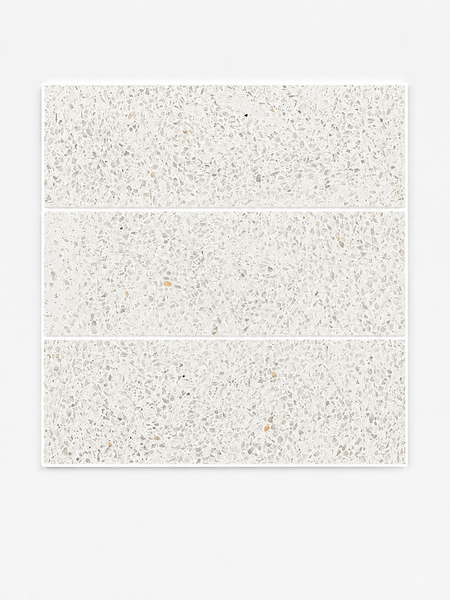 Three Revive Terazzo 4x12 Natural Stone tiles in the color Amplify, featuring a light gray and white speckled pattern reminiscent of elegant Dolomite Marble, are arranged in a vertical stack on a plain white background.