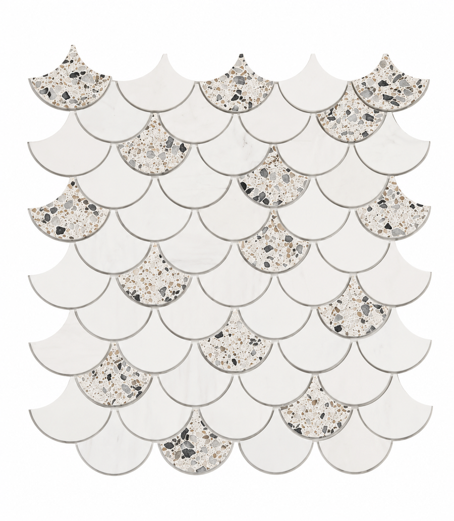 The Revive Terrazzo & Dolomite 2″ Fish Scale Mosaic in Pave features scallop-shaped tiles arranged in a fish scale pattern, alternating between solid white and terrazzo tiles with black and gray stone chips on a white background, evoking the sophisticated interplay of Terrazzo shades and the timeless elegance of Dolomite marble.