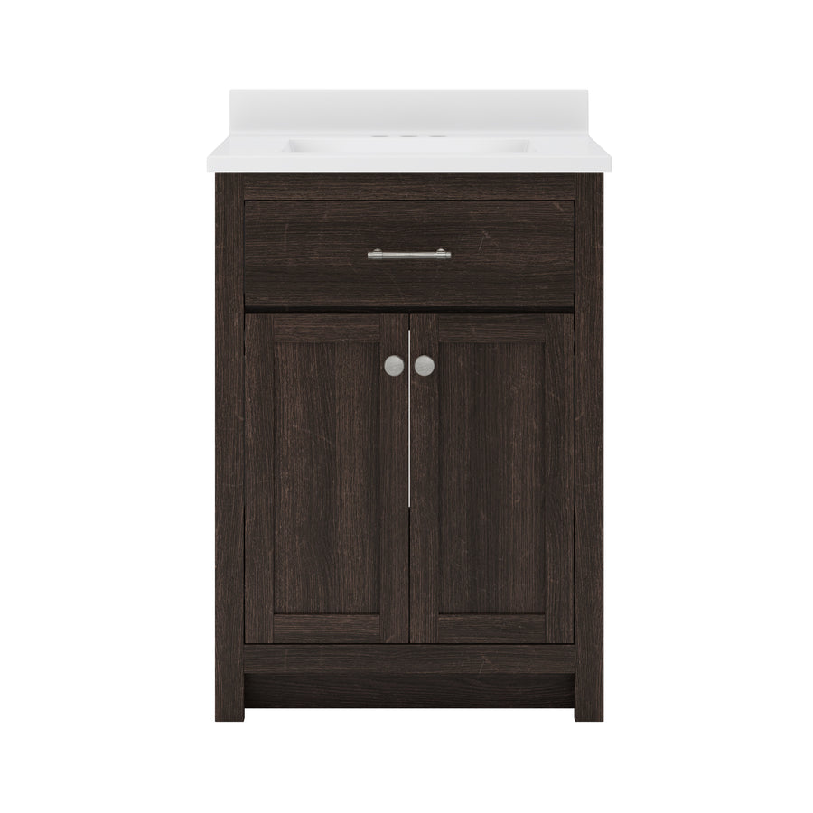 Dark wood bathroom vanity with a white countertop and integrated sink. Features a single metal-handled drawer above double cabinet doors with round silver knobs, set against a plain white background.