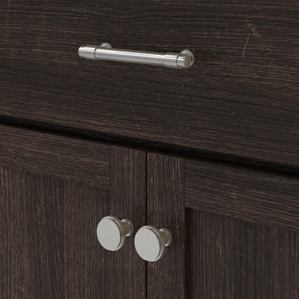 Close-up of dark wood cabinet with two round silver handles on the doors and a horizontal silver bar handle on the drawer above.