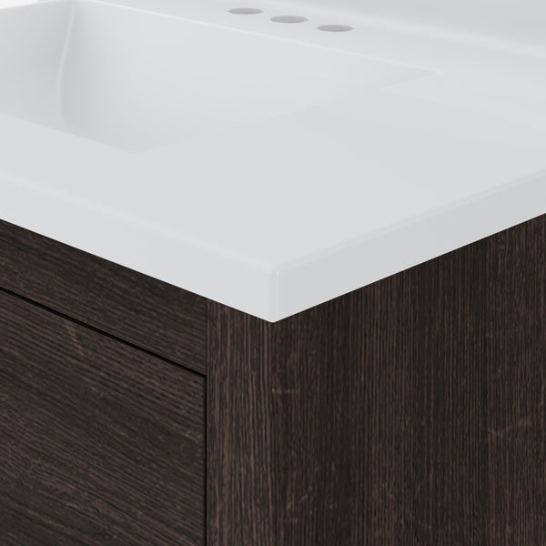 Close-up of a modern bathroom vanity with a white rectangular sink and a dark wood cabinet. The countertop has holes for faucet installation, and the design is sleek and minimalist.