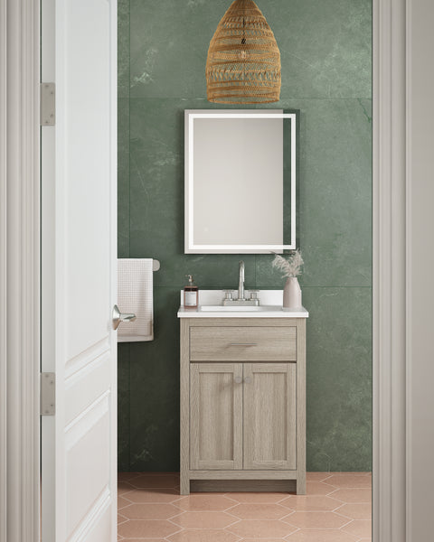 A small bathroom with green walls features the Reese 24