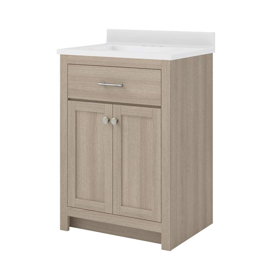 Light wood bathroom vanity with a white countertop, a single drawer with a silver handle, and two cabinet doors with round silver knobs, set against a plain white background.