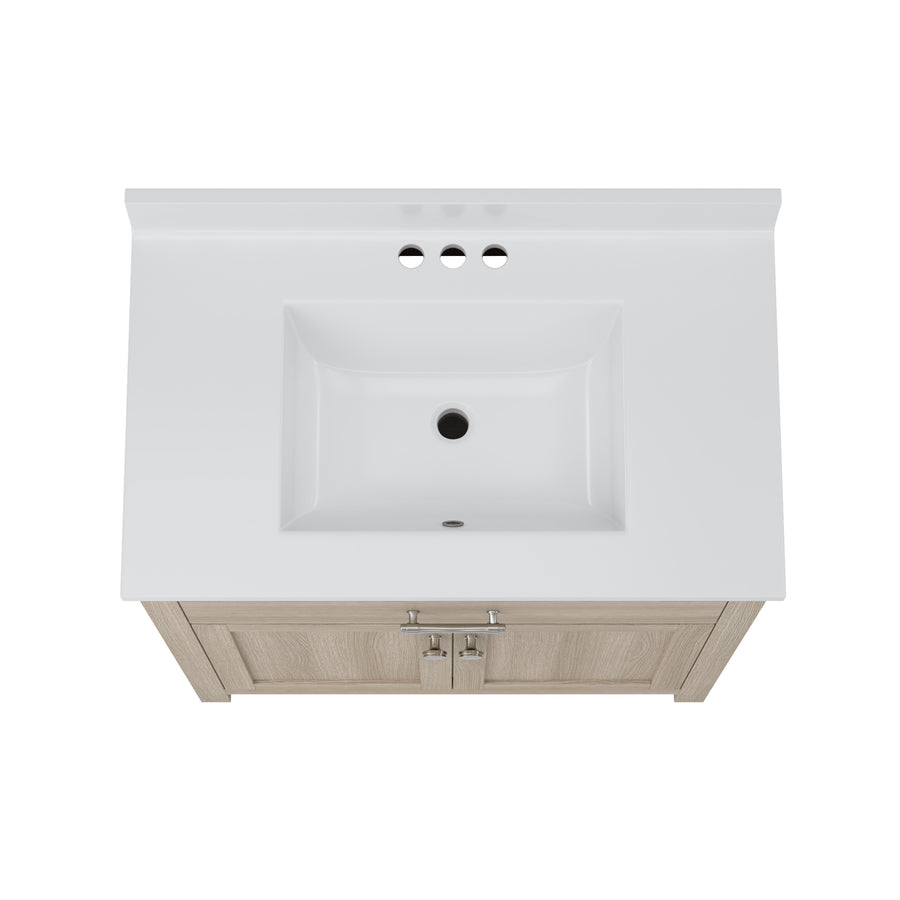 Top view of a white rectangular bathroom sink with three faucet holes and a light wood vanity cabinet featuring two doors and silver handles.