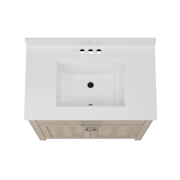 Top view of a white rectangular bathroom sink with three faucet holes and a light wood vanity cabinet featuring two doors and silver handles.