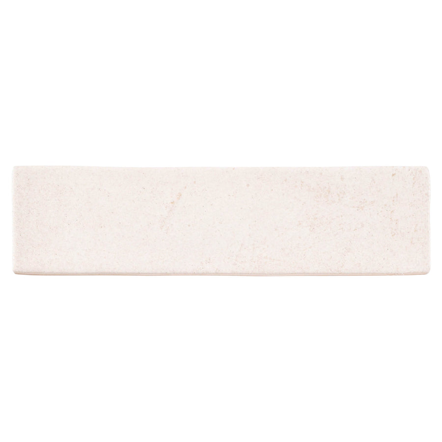 The Rhythmique 3" x 12" Ceramic Subway Tile in Vison features a smooth, matte off-white finish with slightly rounded edges, perfect for modern spaces and inspired by classic subway planks, shown on a plain white background.