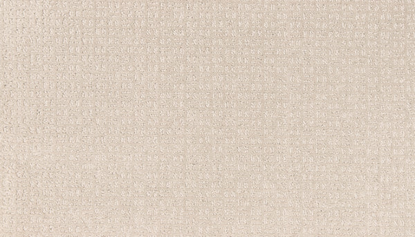 Close-up of the Radiant Space On Trend Carpet in Nomad, featuring a light beige tone with a subtle grid-like or waffle texture that offers a soft, gently cushioned surface and modern, contemporary style.
