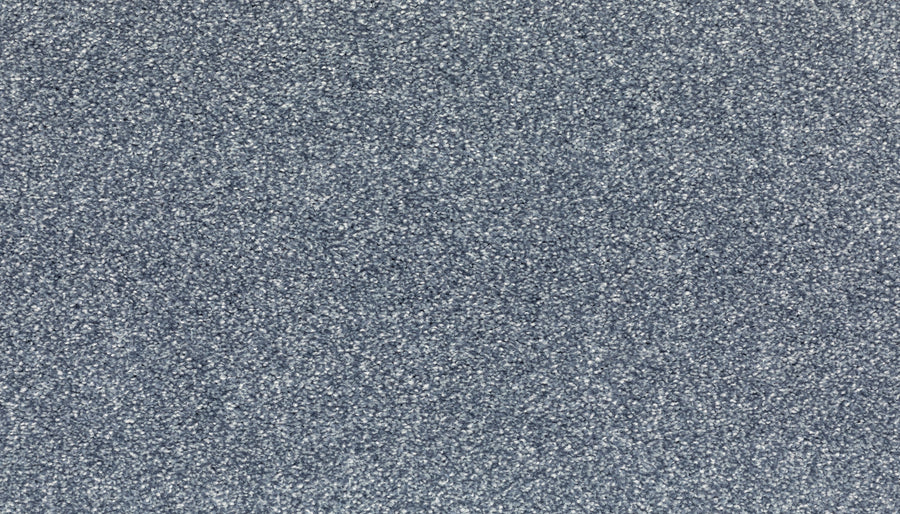 Close-up of Radiant Tone Pet Friendly Carpet in Day Dream color, featuring a textured gray surface with a speckled pattern of light and dark gray particles that create a luxurious look.